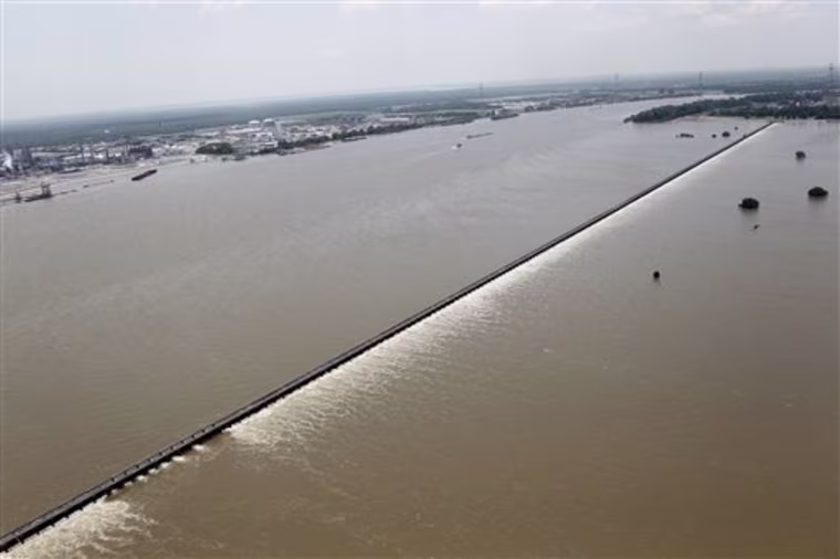Water from the Mississippi River, left, is seen from the air as it is diverted through the floodgates of the Bonnet Carre Spillway towards Lake Pontchartrain (not pictured) in Norco, La., just upriver from New Orleans, Friday, June 3, 2011. (AP Photo/Gerald Herbert)
